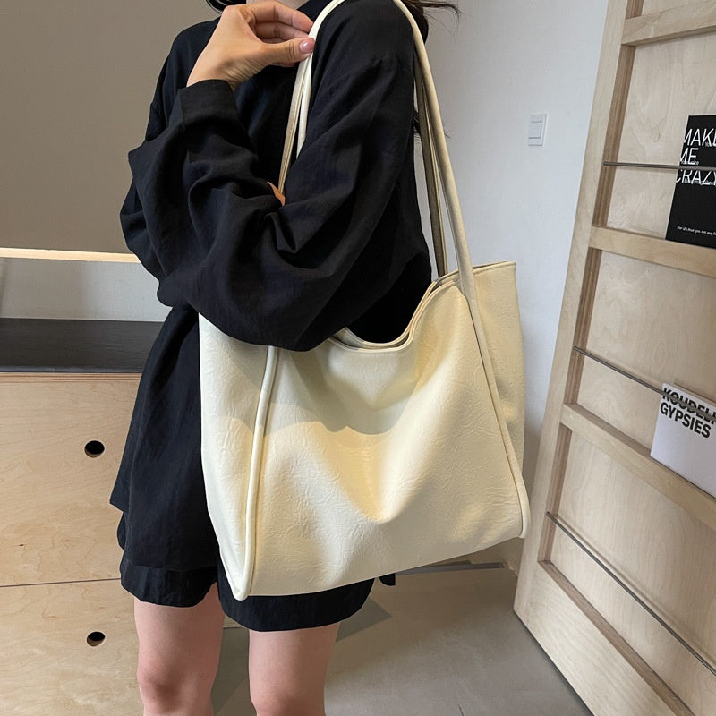 Milky white soft PU leather shoulder tote bag in use