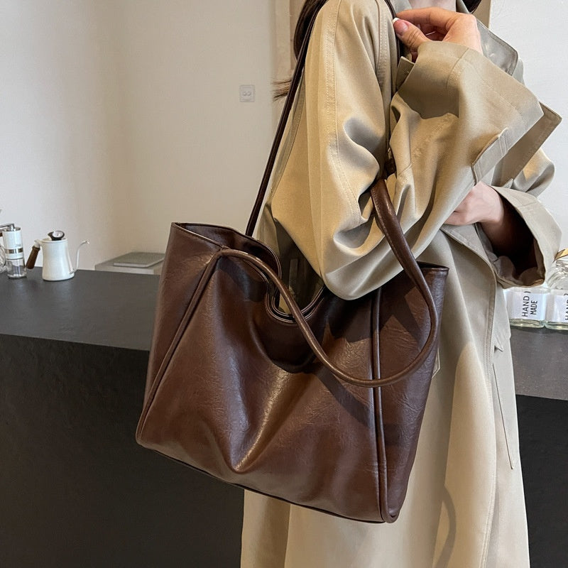 Brown soft PU leather shoulder tote bag in use