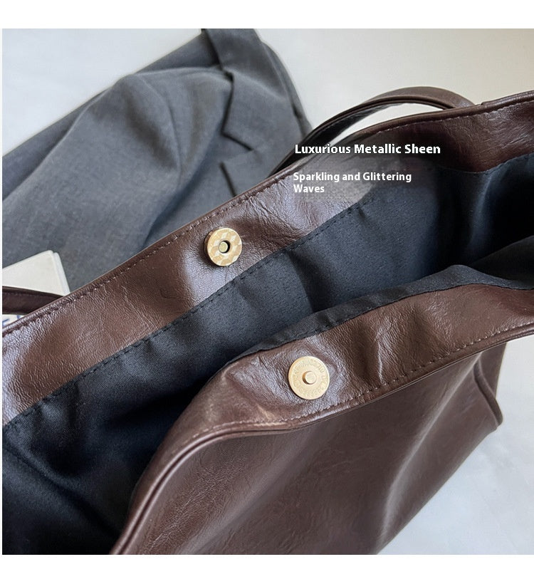 Magnetic snap closure detail on the soft PU leather tote bag